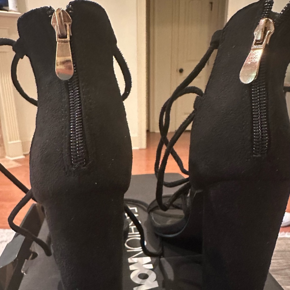 Black strap up the leg block heels.